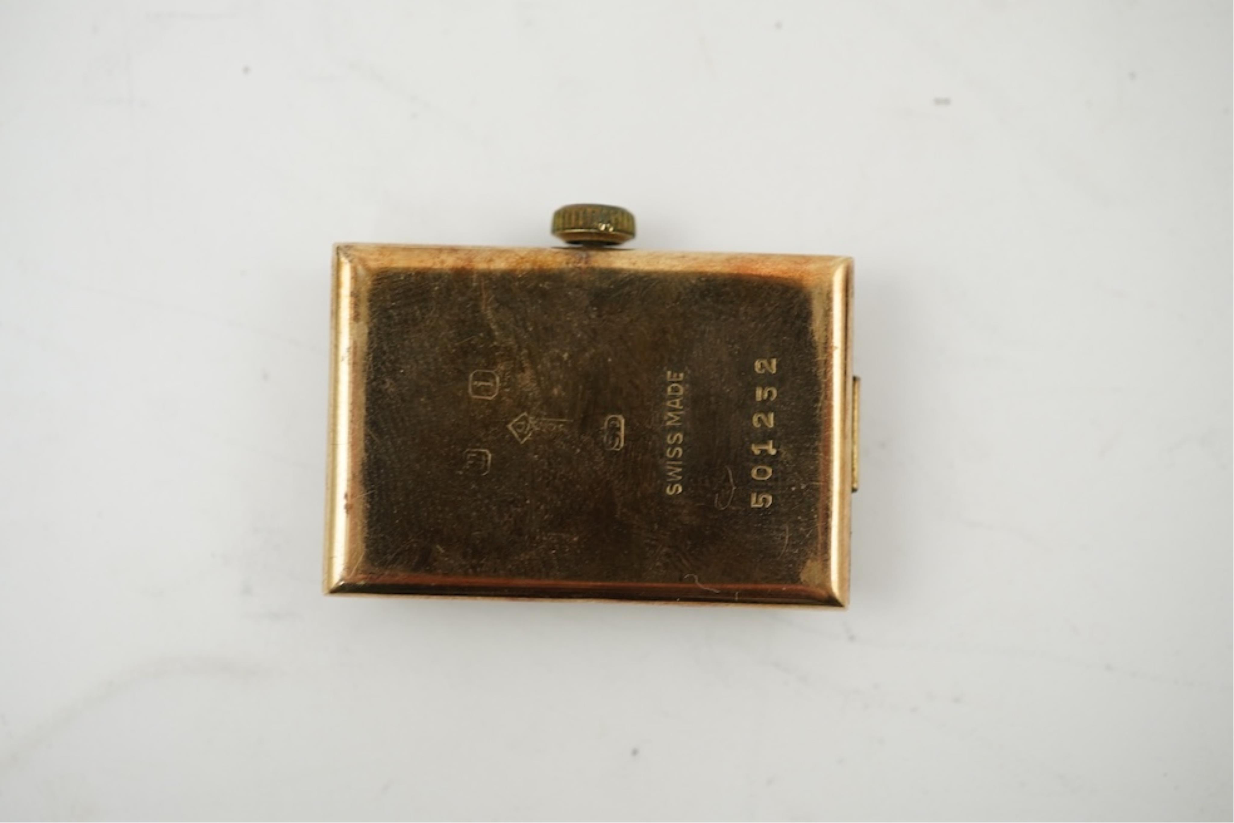 An early 1930's 9ct gold Swiss 'Jump Hour' rectangular cased manual wind wrist watch, case diameter 20mm, on a leather strap, gross weight 23 grams.